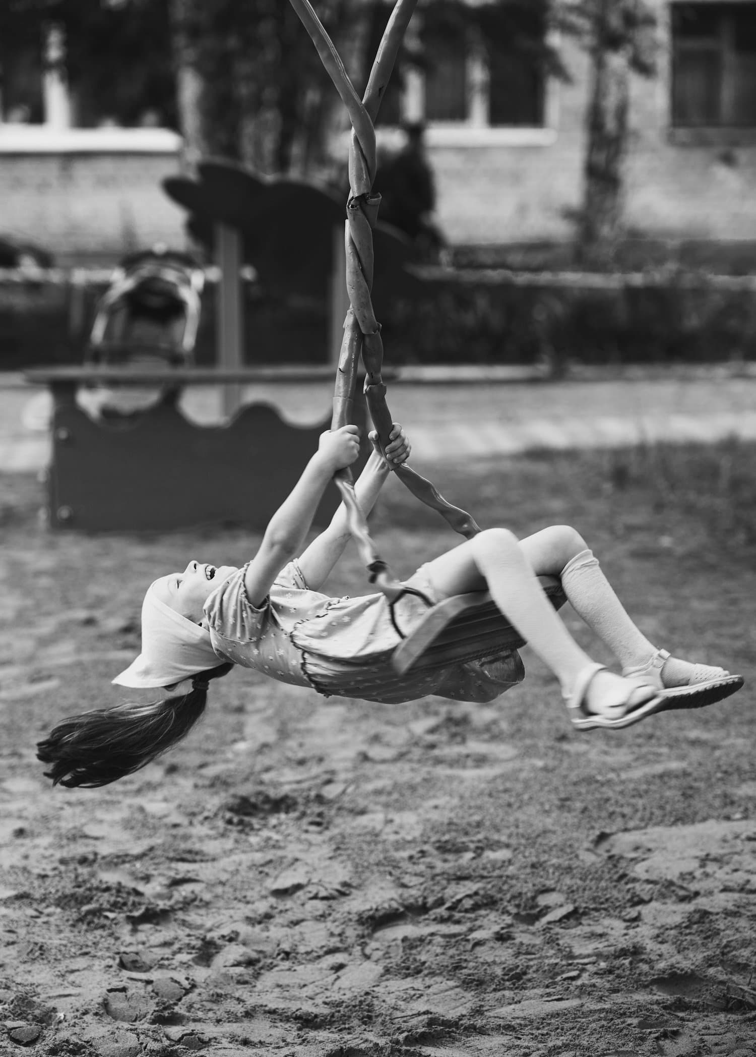 A child on a swing, mid-flight