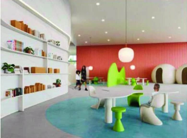 A bright, open learning space with white shelving, a curved table and soft round seating pods