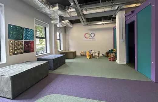 A bright open room at the NDI centre with low seating and soft furniture