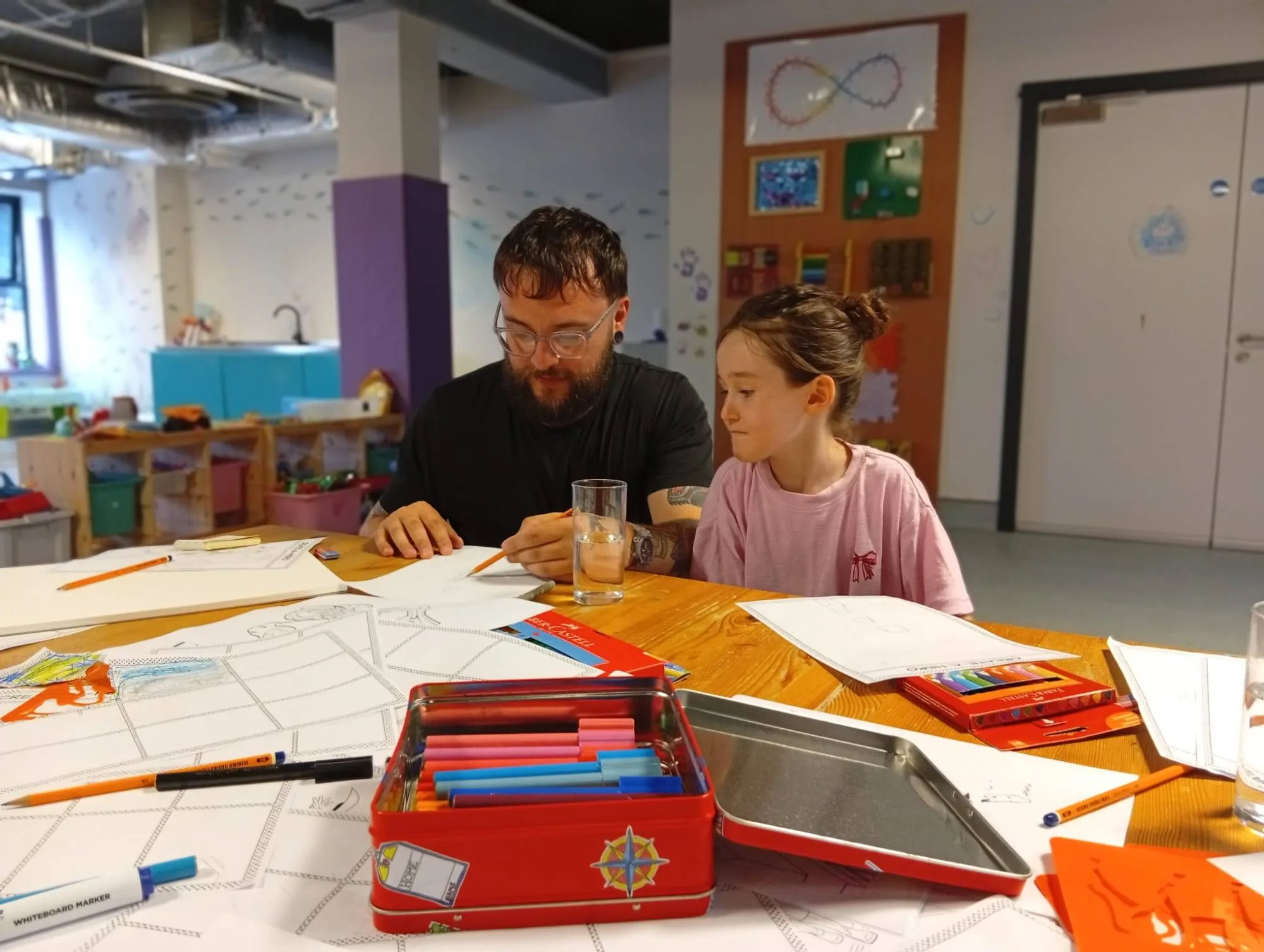 child and adult doing art side by side at Sensory Centre