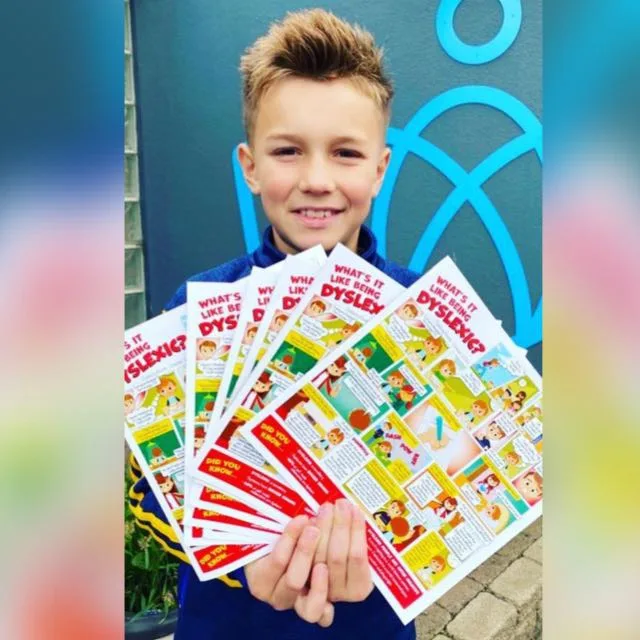 Child holding comic leaflet helping children understand Dyslexia